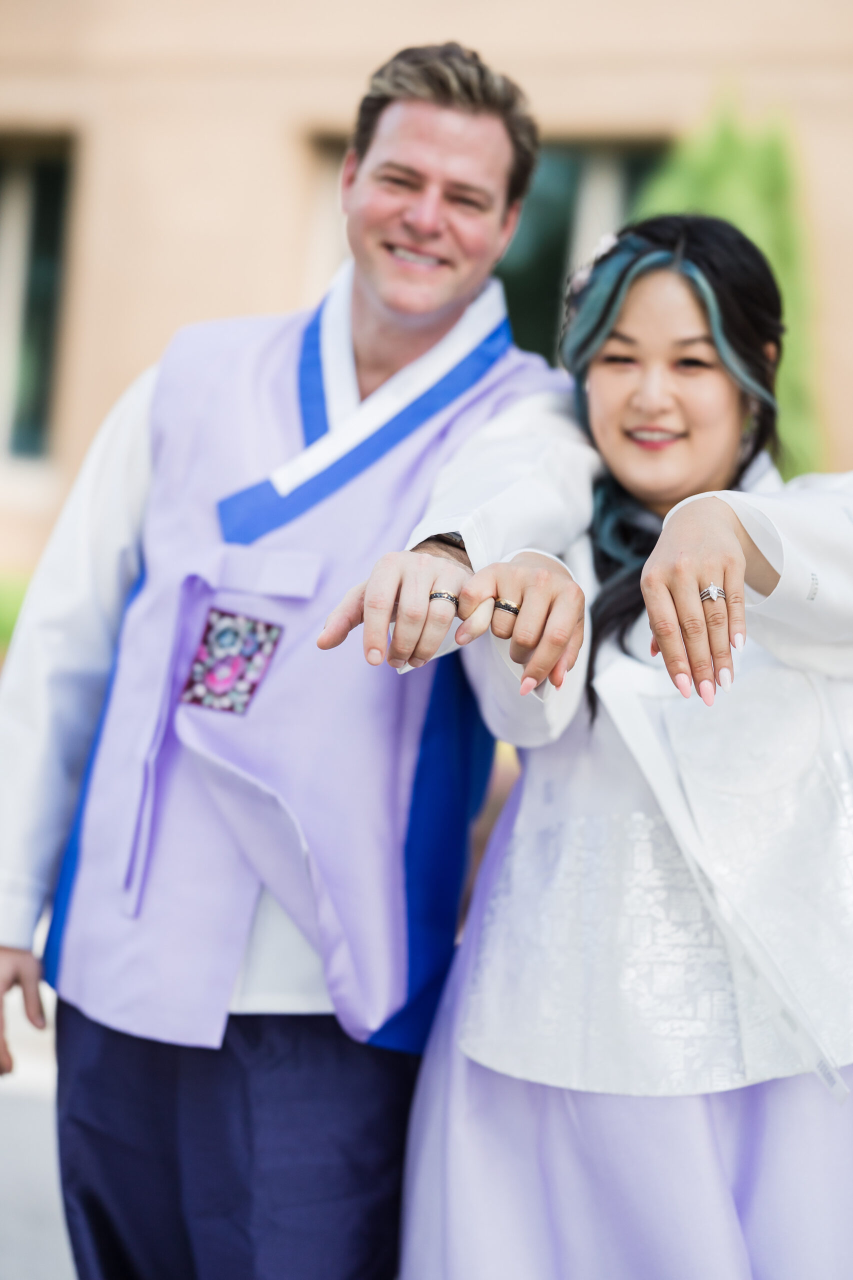 Bride and Groom romantically posing and showing off their beautiful wedding rings