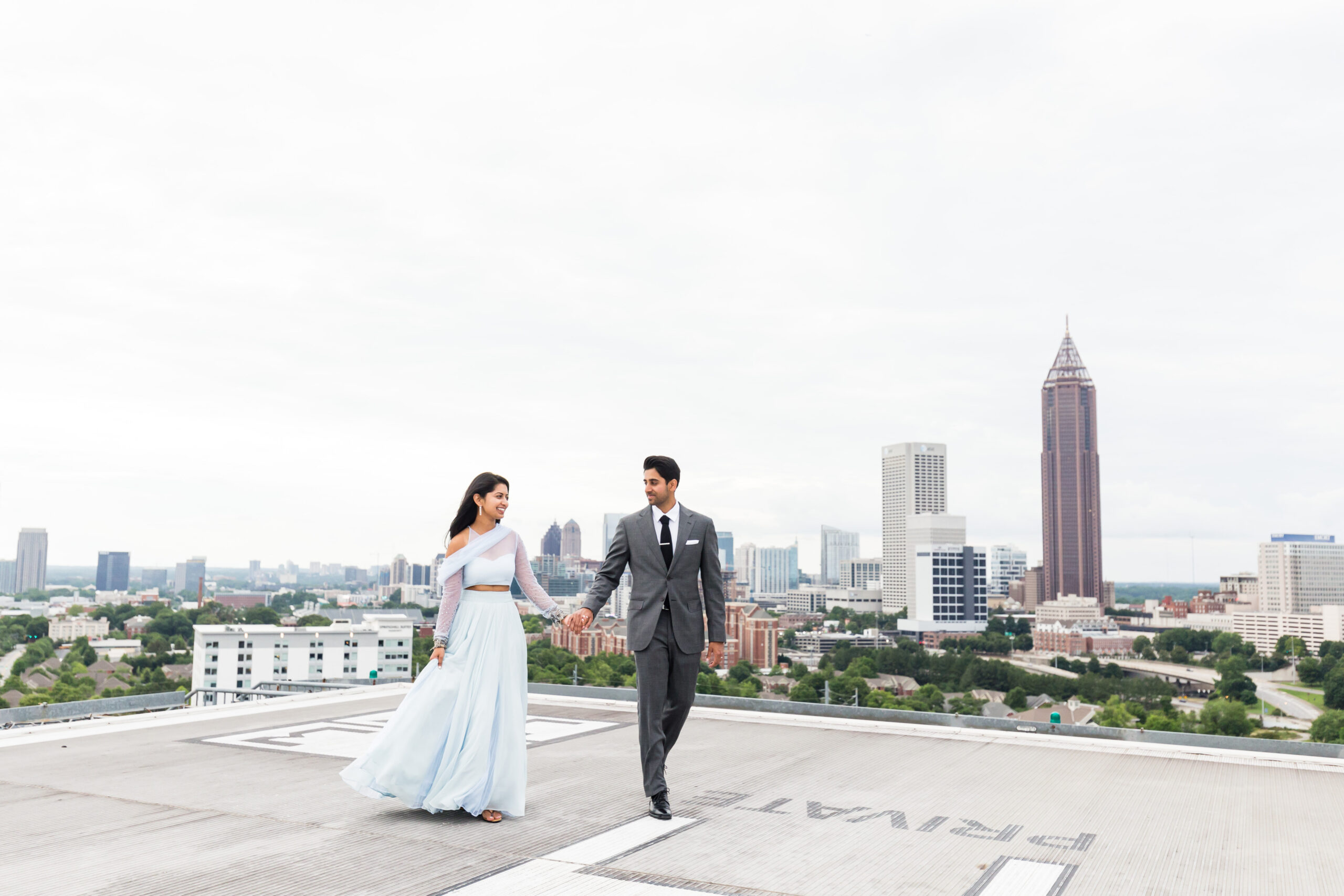 Bride and Groom on a rooftop looking at each other's eyes while walking