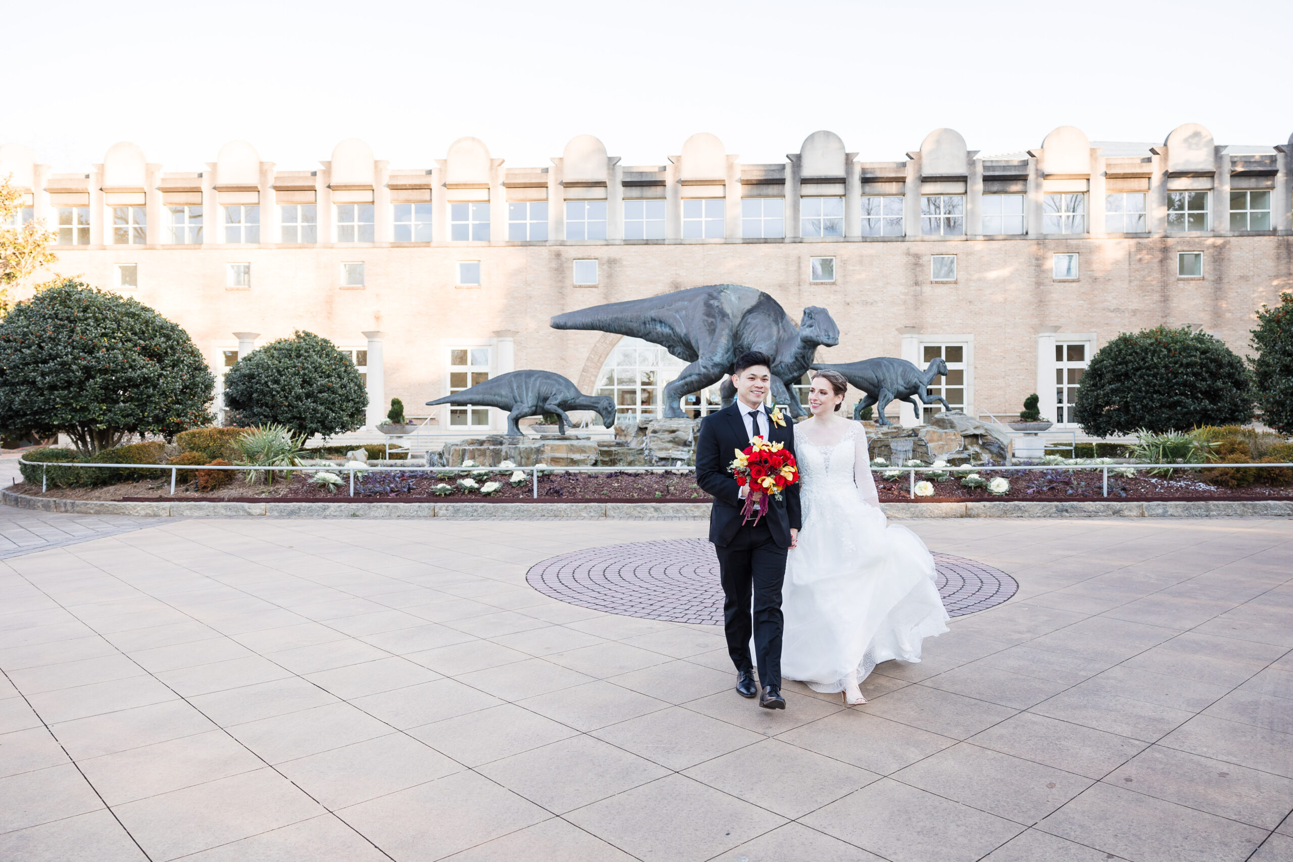Brian and Rochelle holding hands at the front facade of Fernbank Museum