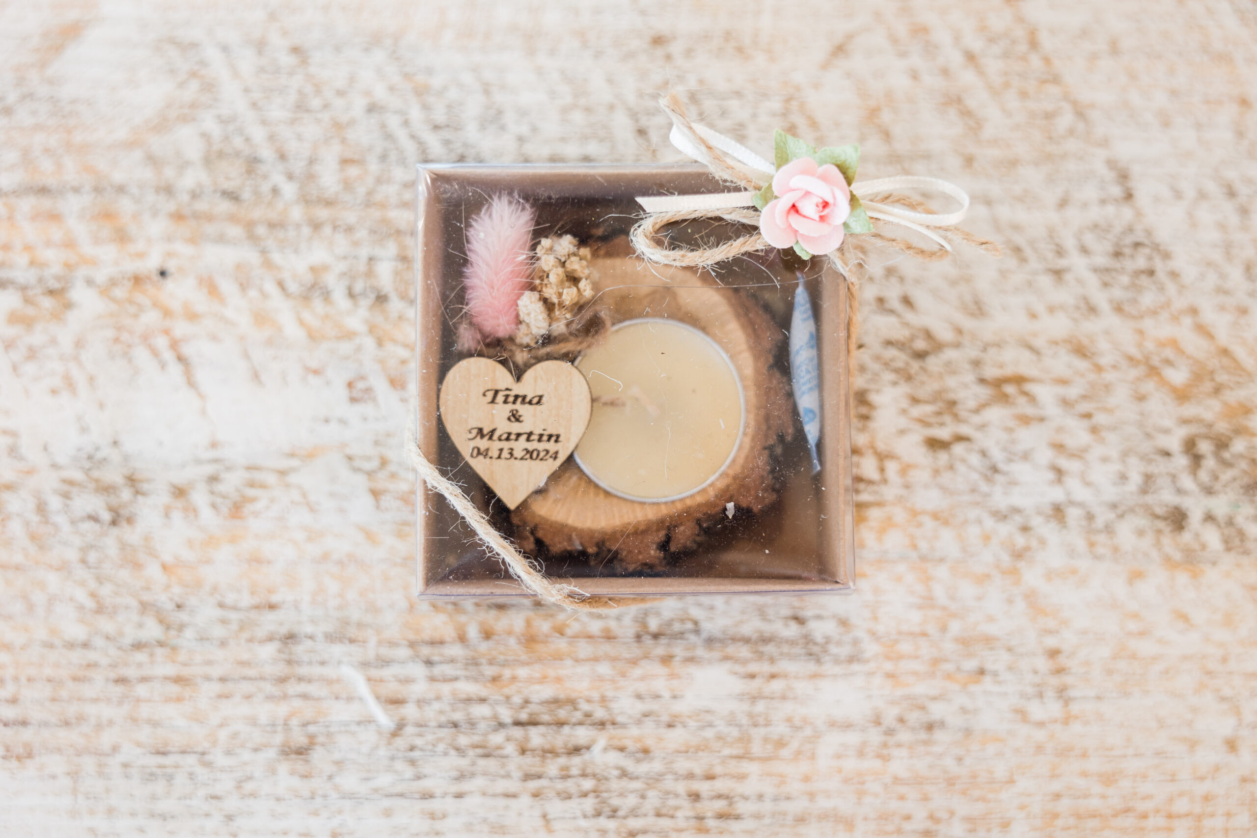 Wedding favor enclosed in a small brown box and pink ribbon
