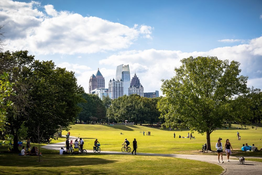 Park with manicured lawn and trees with the Atlanta skyline in the background