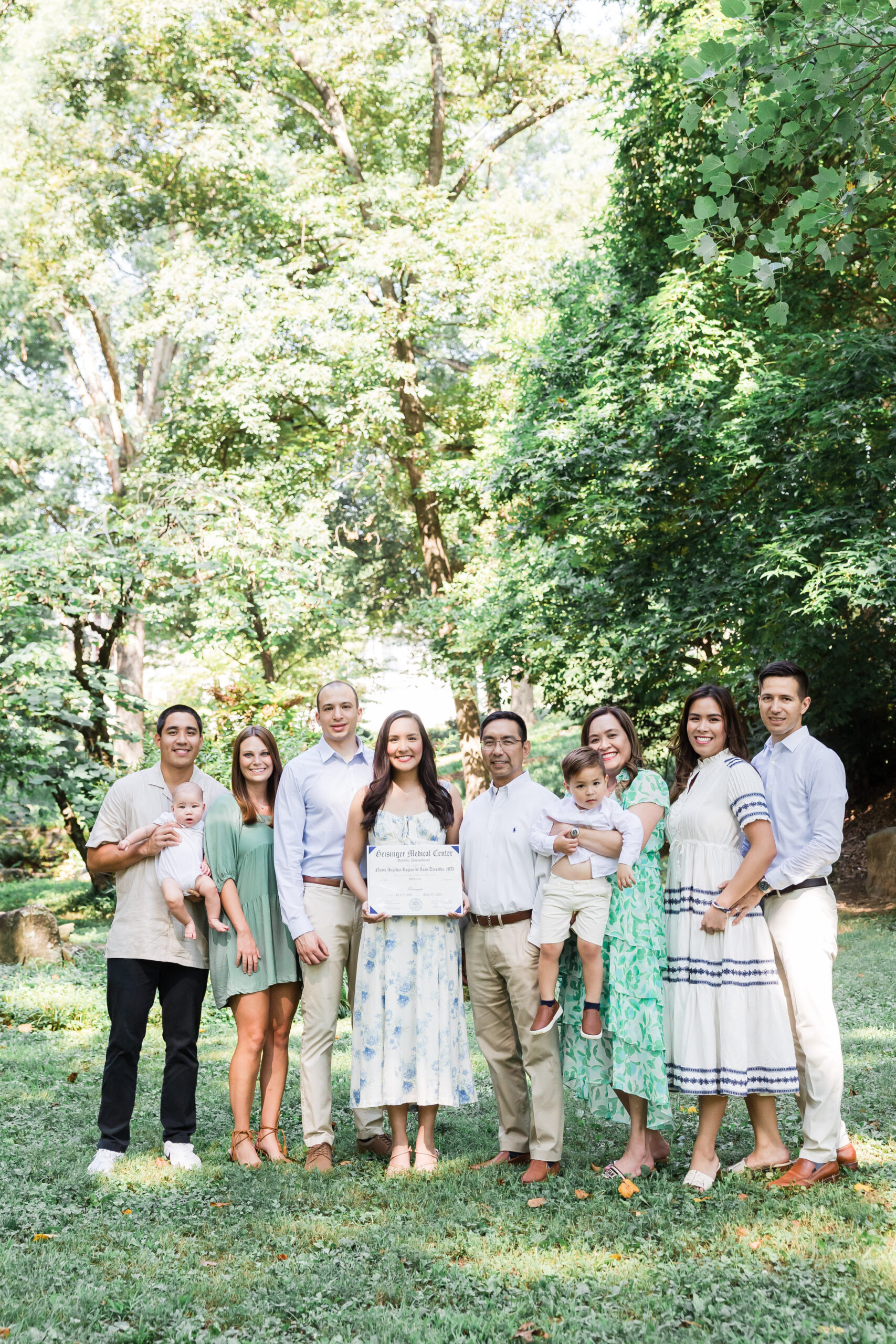 a whole family with the mom, dad, their children, and their grandkids pose for a photo while smiling