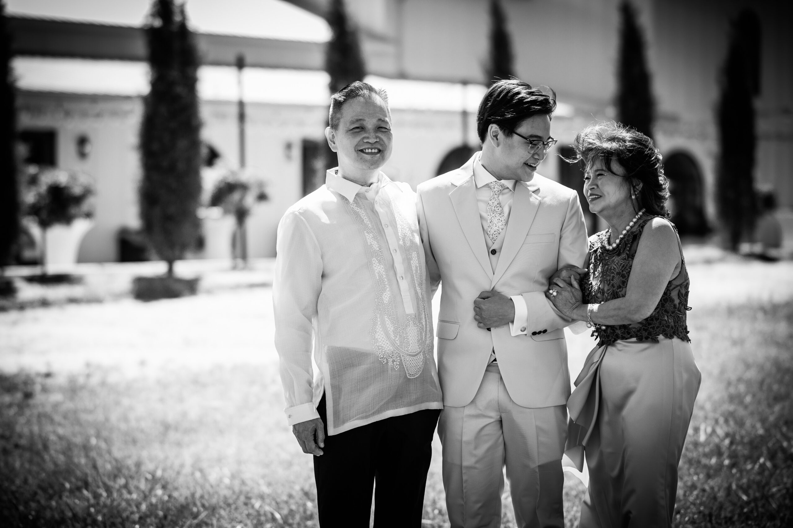 Mom and Dad stand happily with their son in the center