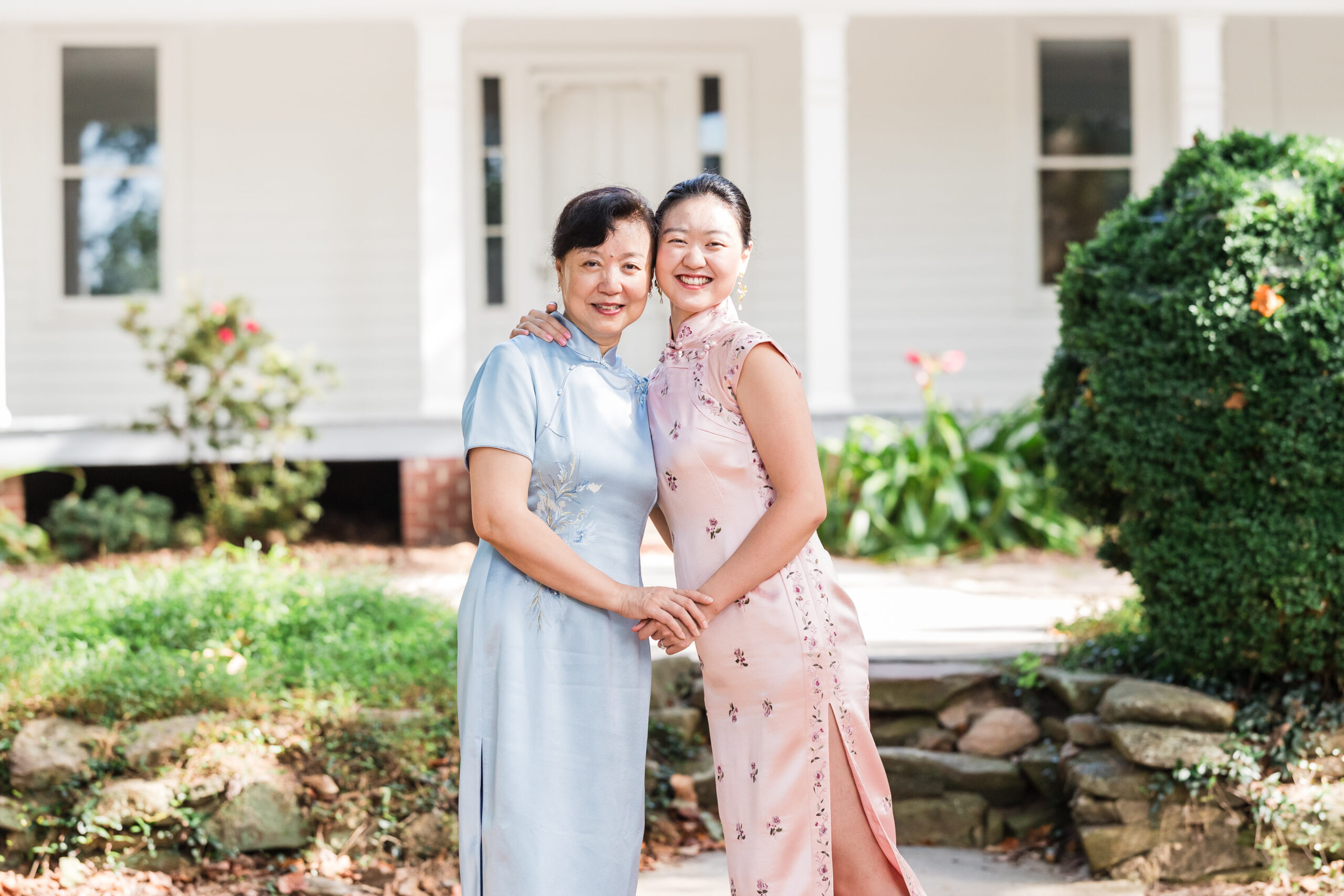 mother and daughter side hug and hold each other hands