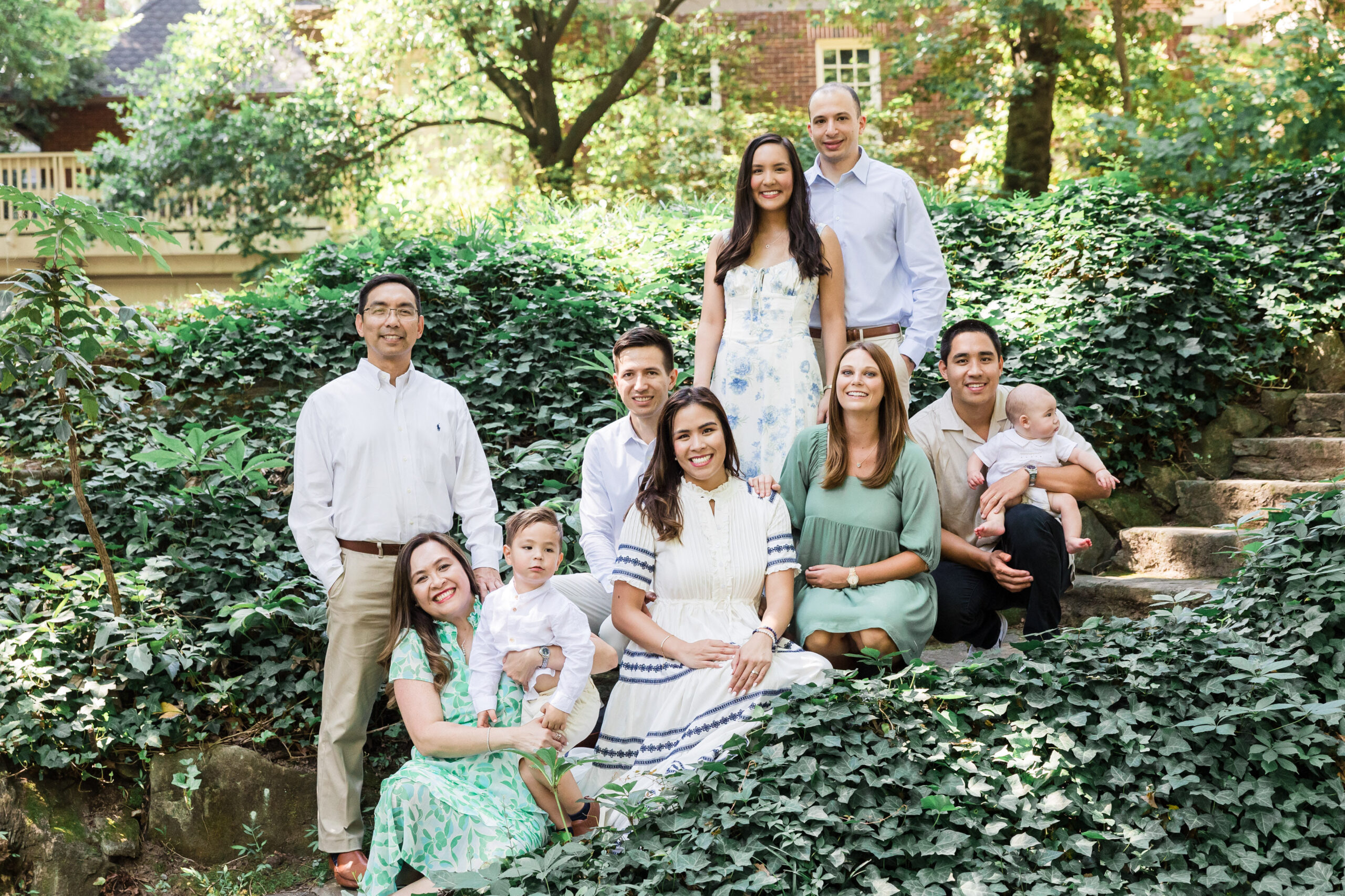 family sitting on the stairs with nature surrounding them