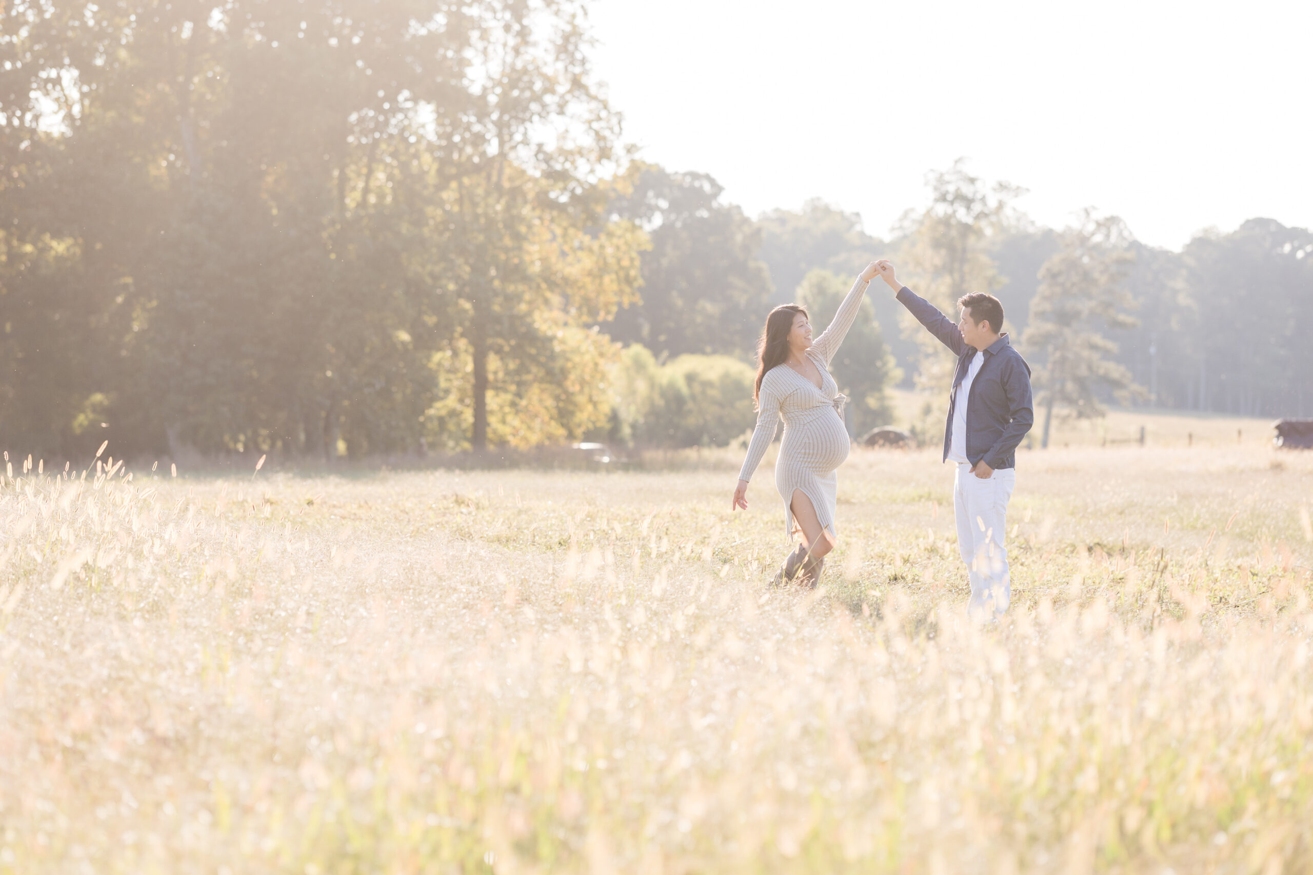 pregnant mom and dad dance in the meadow