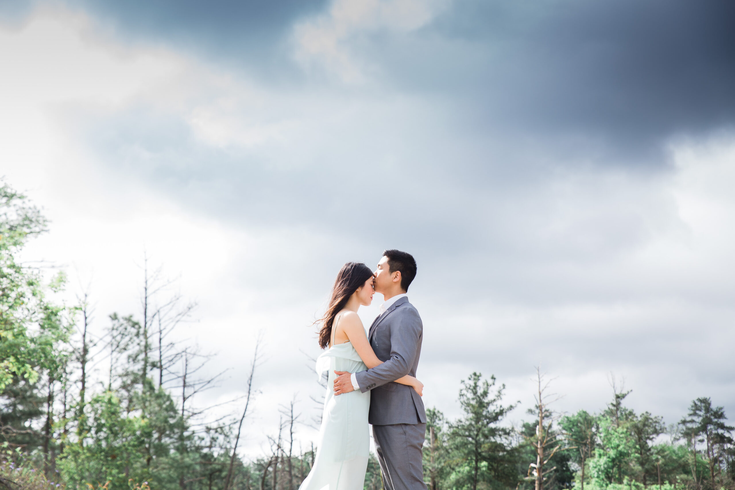 groom kisses his bride's forehead