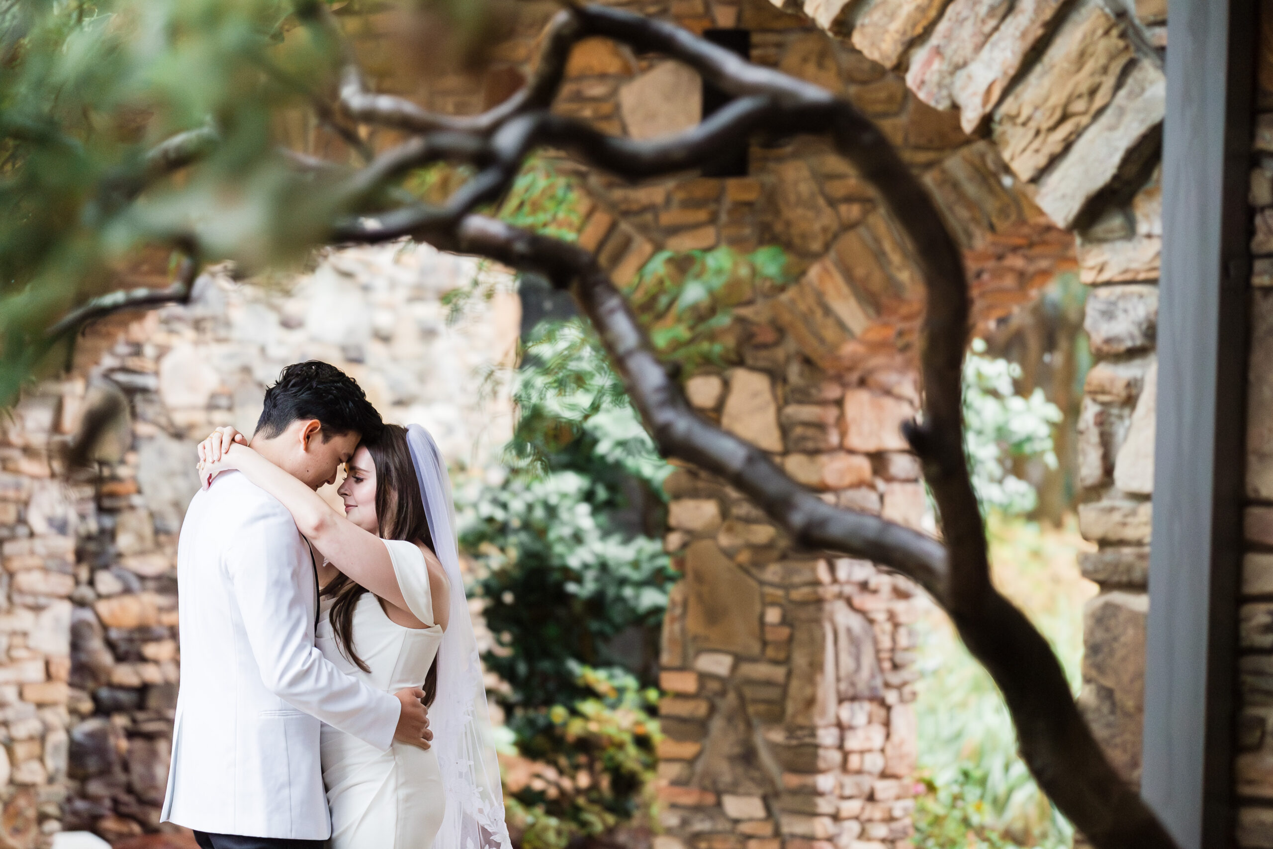 bride and groom embrace as they look into each other's eyes